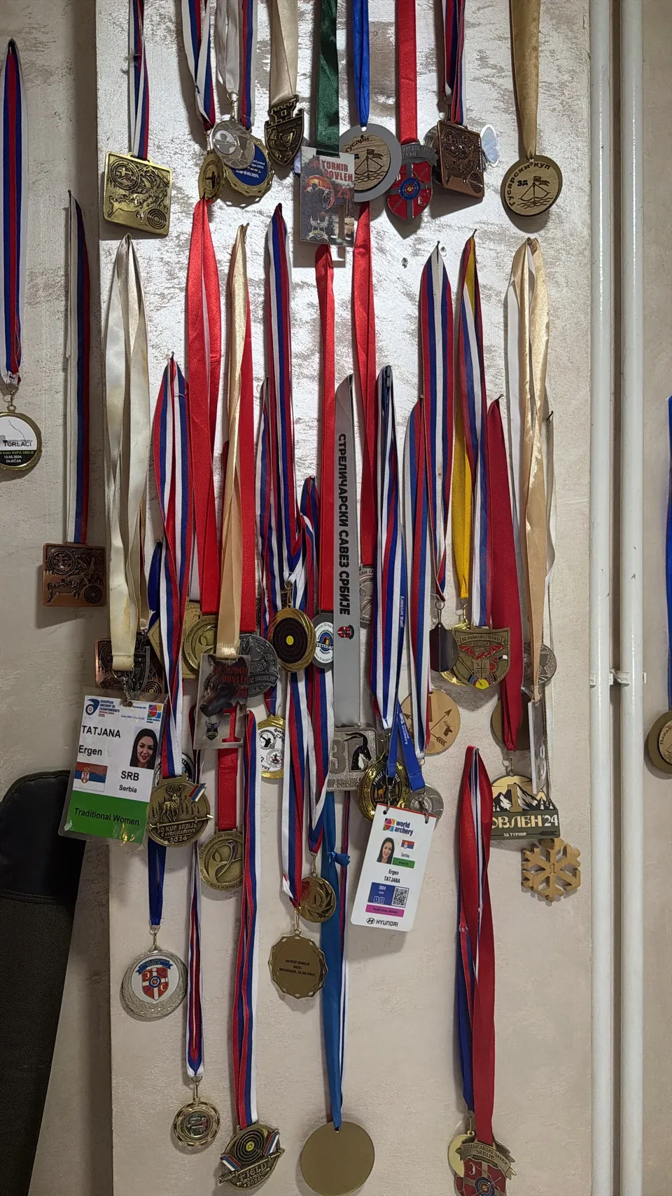 A wall of archery medals